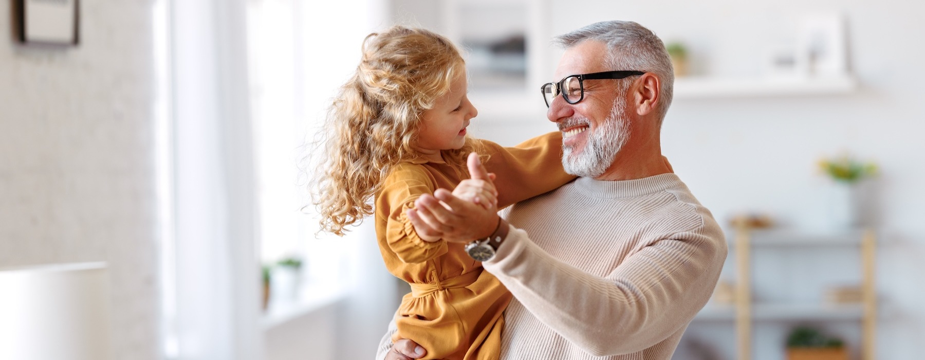 a man holding a girl and smiling
